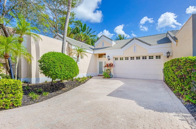 16334 Port Dickinson Dr, Jupiter, FL 33477 - view of front facade featuring a garage