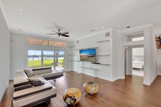 living room with crown molding, dark wood-type flooring, and ceiling fan