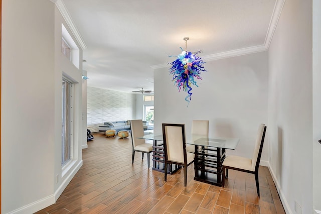 dining area with ornamental molding, wood-type flooring, and ceiling fan