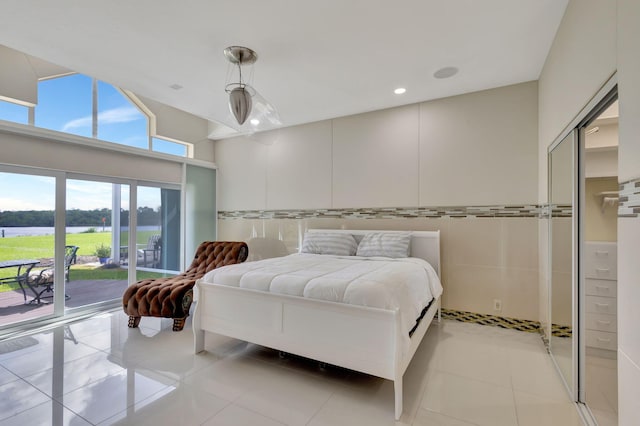 bedroom featuring access to exterior and light tile patterned floors