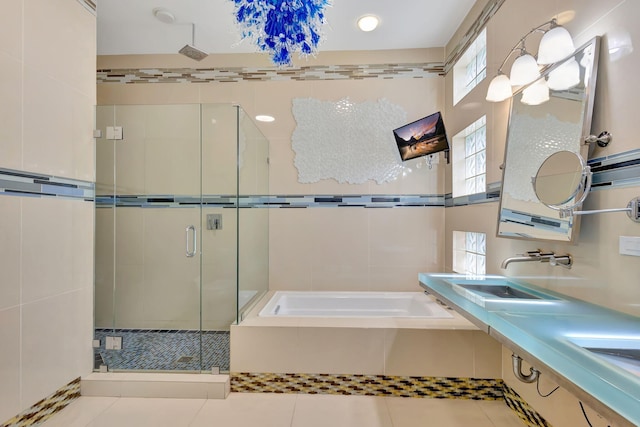 bathroom with tile patterned flooring, dual sinks, and shower with separate bathtub