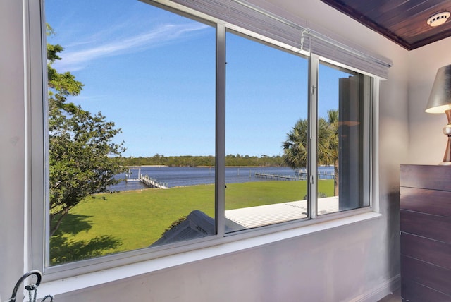 interior space with a water view, wooden ceiling, and plenty of natural light