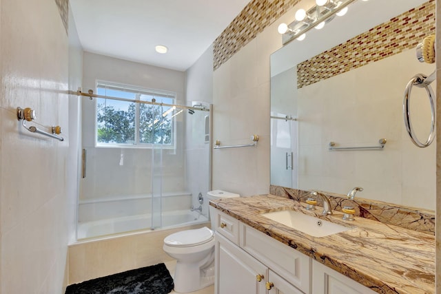 full bathroom with vanity, combined bath / shower with glass door, and toilet