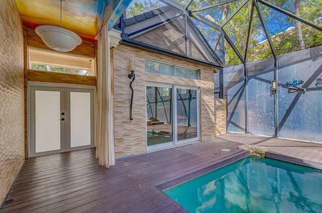 view of swimming pool with a deck and a lanai