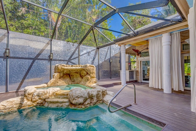 view of pool featuring a lanai and a deck