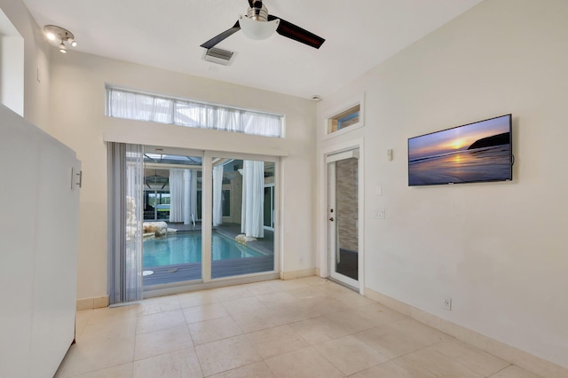 spare room with light tile patterned floors and ceiling fan