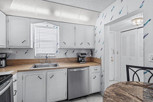 kitchen featuring white cabinets, stainless steel appliances, and sink