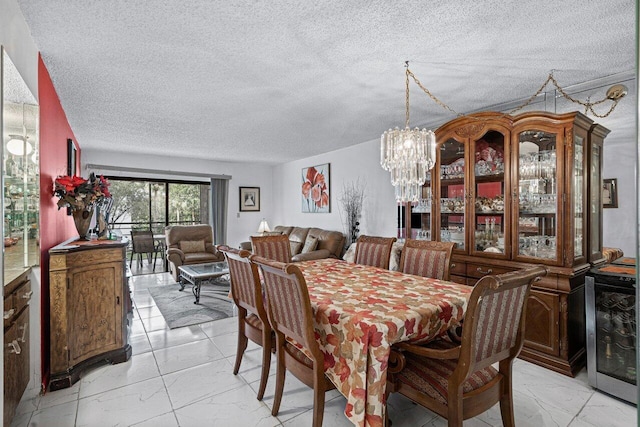 dining room with beverage cooler, a textured ceiling, and a notable chandelier