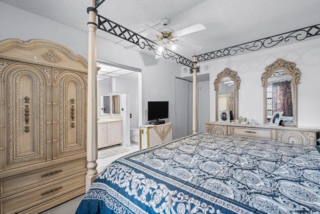 bedroom with a textured ceiling, light colored carpet, ceiling fan, and ensuite bathroom