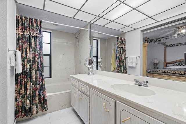 bathroom with shower / bath combo, vanity, and a paneled ceiling