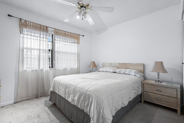 carpeted bedroom with a textured ceiling and ceiling fan