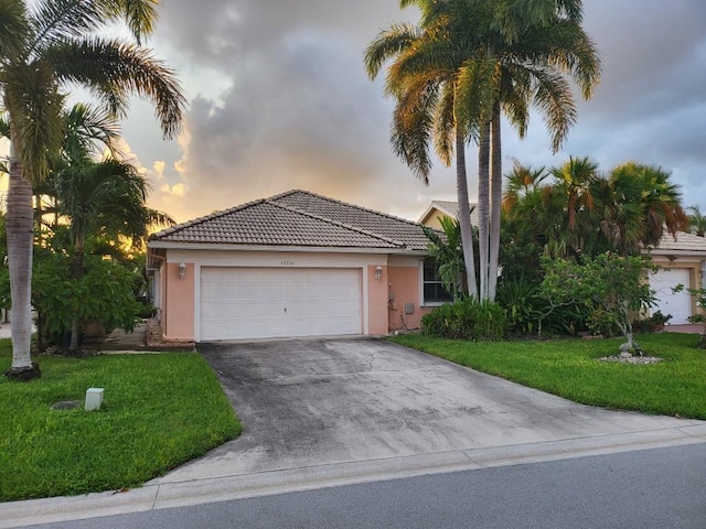 view of front of home featuring a yard and a garage