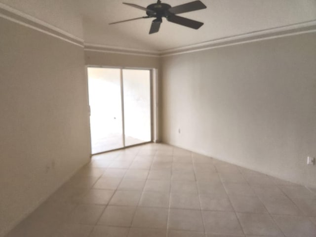 spare room with crown molding, light tile patterned floors, and ceiling fan