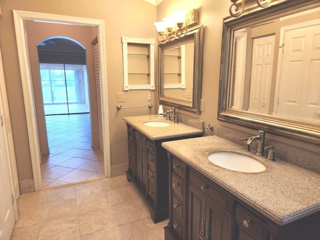 bathroom with vanity, crown molding, and tile patterned floors