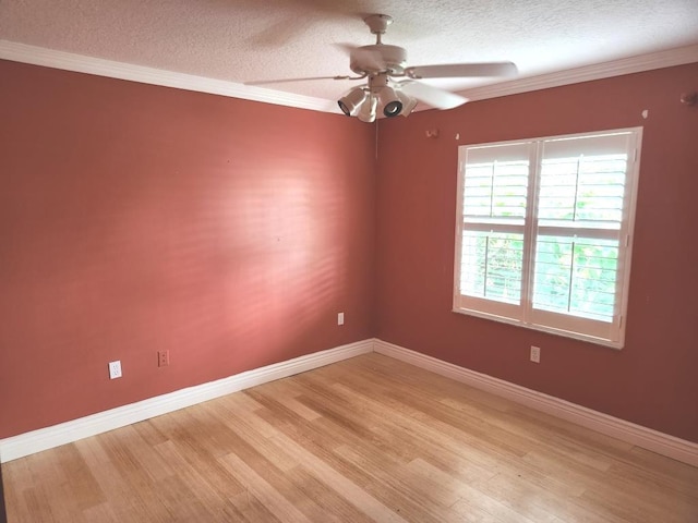 empty room with ornamental molding, a textured ceiling, light wood-type flooring, and ceiling fan