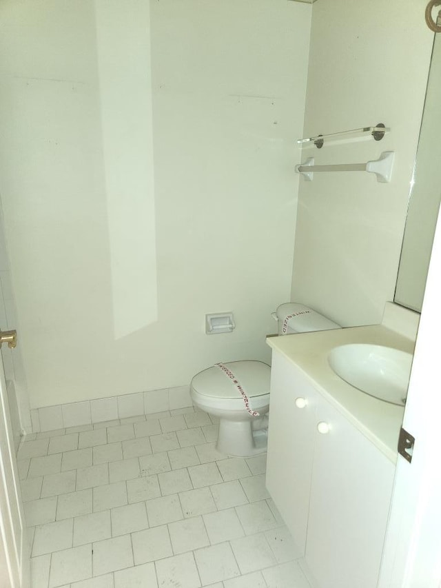 bathroom with vanity, toilet, and tile patterned floors