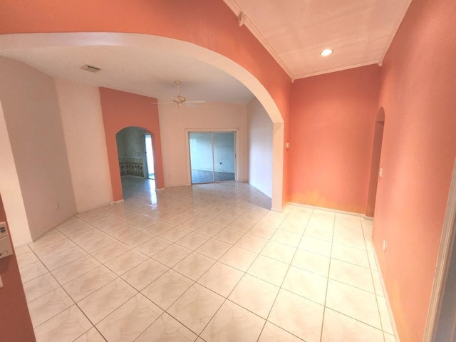 unfurnished room featuring ornamental molding, light tile patterned floors, and ceiling fan