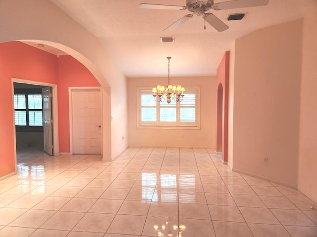 tiled spare room featuring a textured ceiling and ceiling fan with notable chandelier