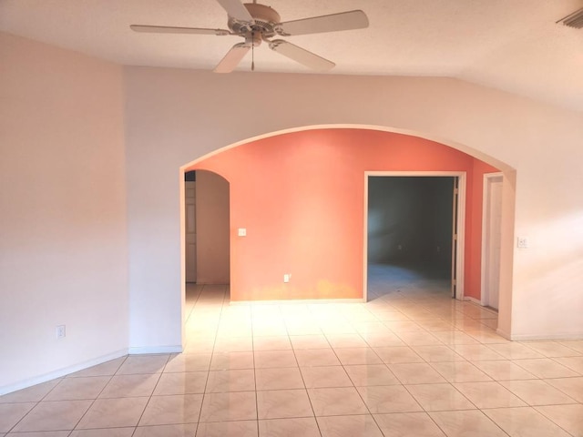 tiled spare room featuring ceiling fan and lofted ceiling