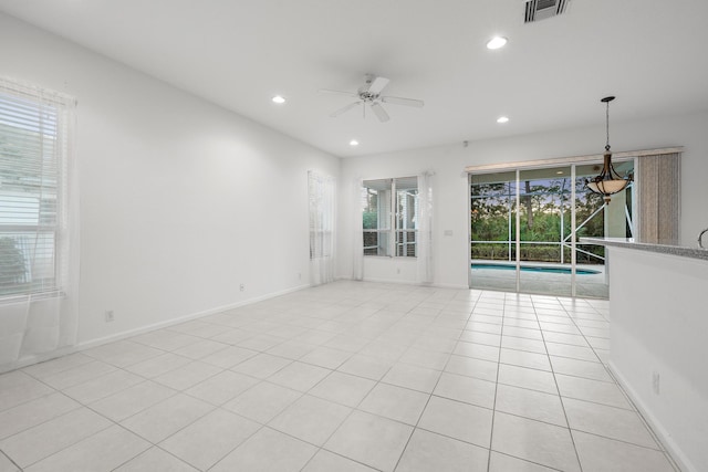 spare room with ceiling fan and light tile patterned floors