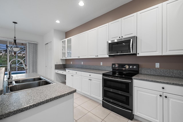 kitchen featuring white cabinetry, light tile patterned floors, stainless steel appliances, and sink