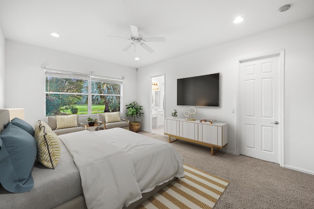 carpeted bedroom featuring ensuite bathroom and ceiling fan