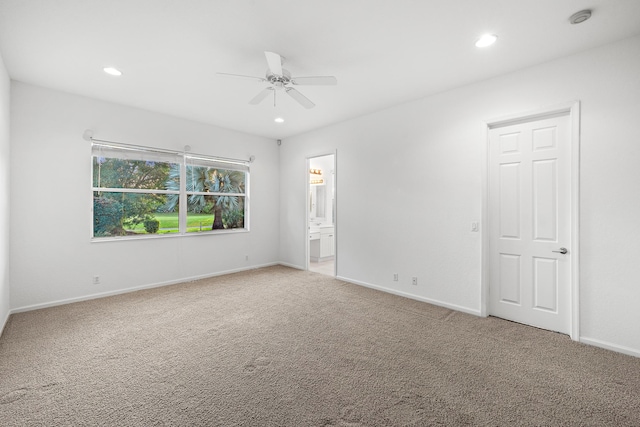 spare room with carpet floors and ceiling fan