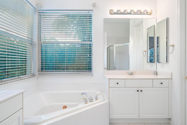 bathroom with vanity and shower with separate bathtub