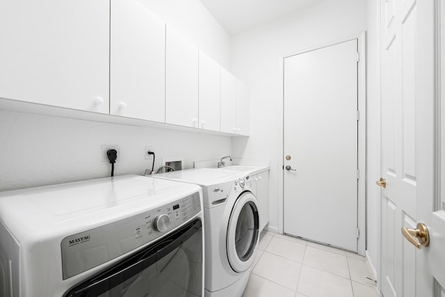 washroom featuring cabinets, independent washer and dryer, light tile patterned flooring, and sink