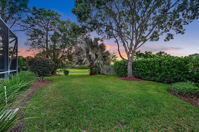 view of yard at dusk