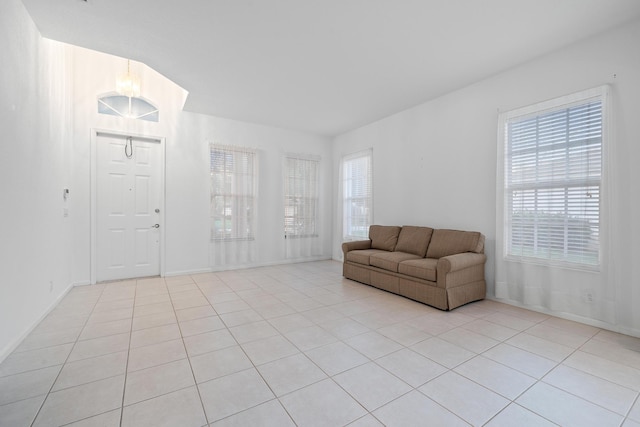 unfurnished living room with a healthy amount of sunlight and light tile patterned flooring