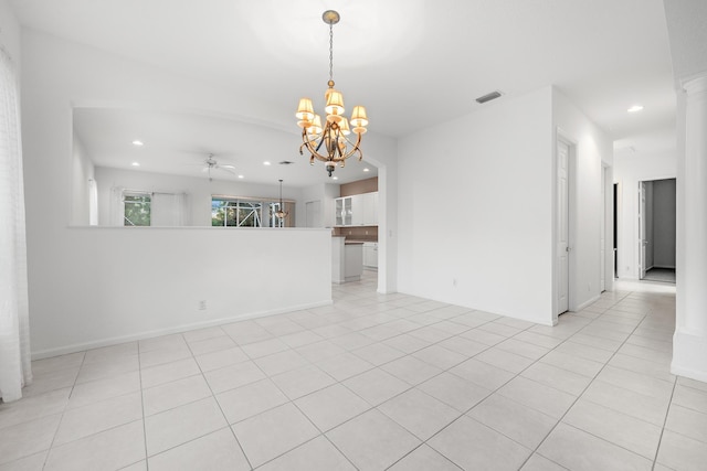 spare room featuring light tile patterned flooring, ceiling fan with notable chandelier, and decorative columns