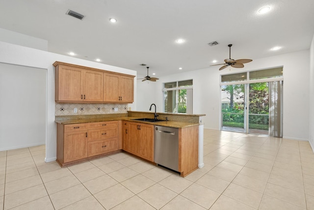 kitchen with backsplash, light tile patterned floors, sink, dishwasher, and kitchen peninsula