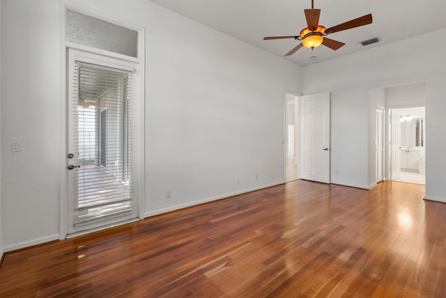 unfurnished bedroom with hardwood / wood-style floors, ceiling fan, and connected bathroom