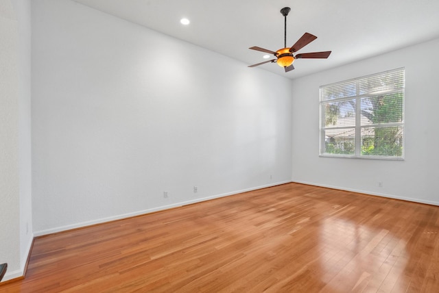 spare room with ceiling fan and light wood-type flooring