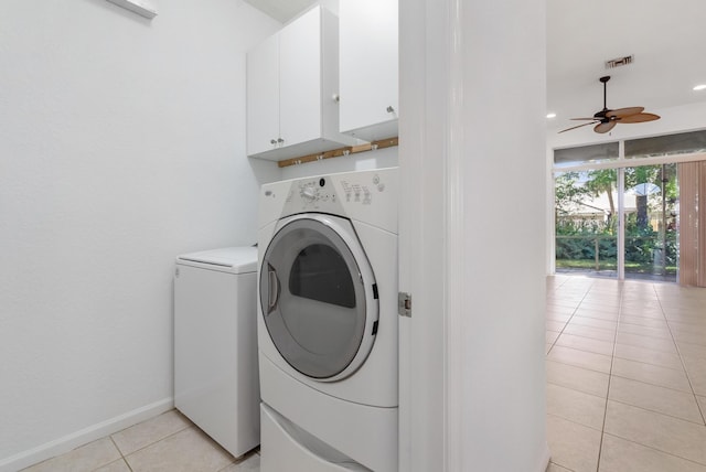 washroom with cabinets, light tile patterned flooring, ceiling fan, and washing machine and clothes dryer