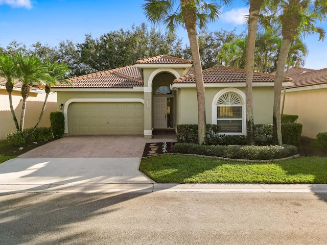 mediterranean / spanish-style house with a garage