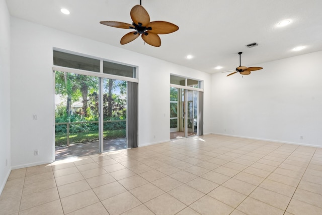 unfurnished room with ceiling fan and light tile patterned flooring