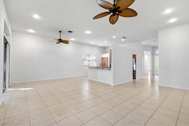 tiled spare room with a wealth of natural light and ceiling fan