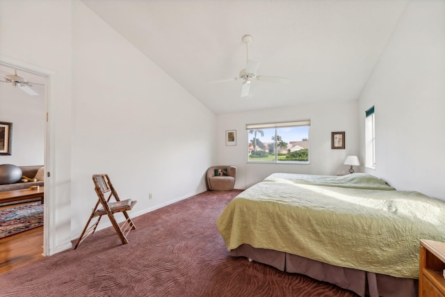 bedroom with carpet floors, ceiling fan, baseboards, and vaulted ceiling