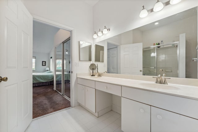 full bathroom featuring a sink, double vanity, a stall shower, and ensuite bath