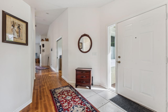 entrance foyer featuring light wood-style floors and baseboards