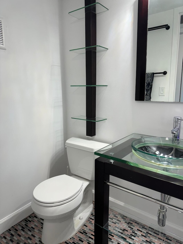 bathroom featuring vanity, toilet, and tile patterned floors