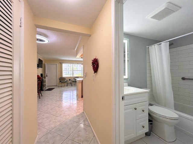 full bathroom featuring vanity, shower / tub combo with curtain, toilet, and tile patterned floors