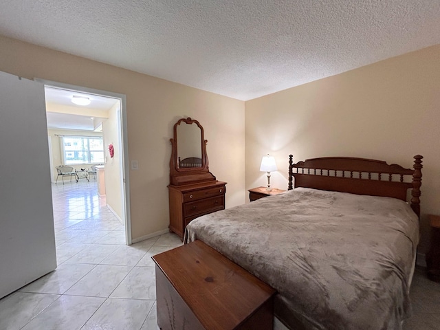 bedroom featuring a textured ceiling and light tile patterned flooring