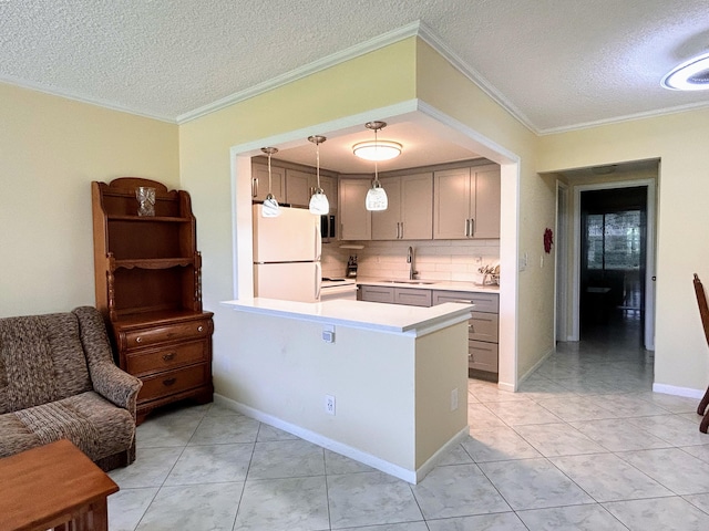 kitchen with white appliances, a textured ceiling, kitchen peninsula, pendant lighting, and crown molding