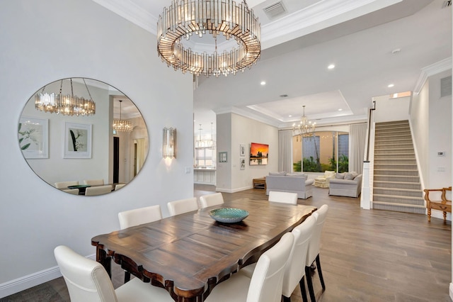 dining space with a tray ceiling, crown molding, and dark hardwood / wood-style floors