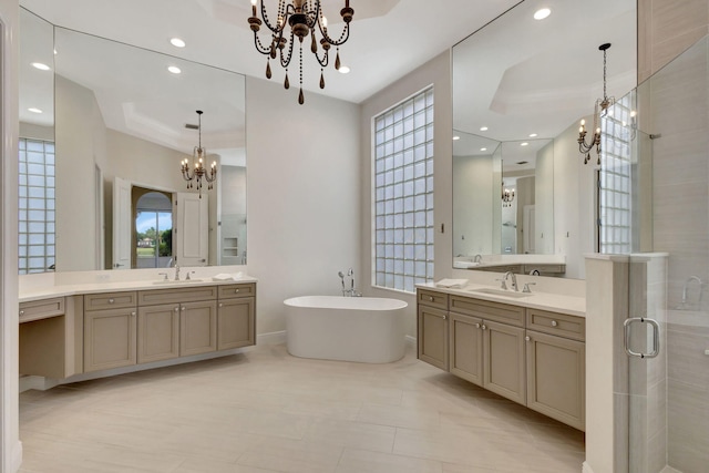 bathroom featuring vanity, plus walk in shower, and an inviting chandelier