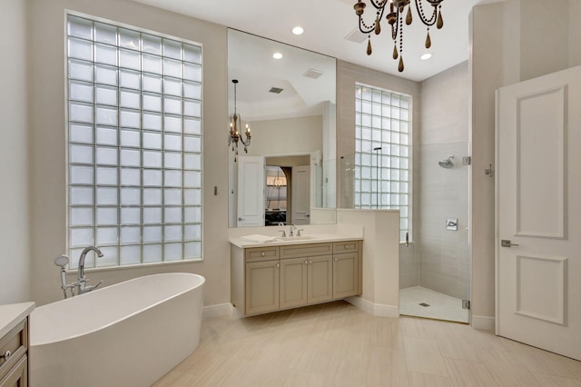 bathroom with vanity, independent shower and bath, and an inviting chandelier