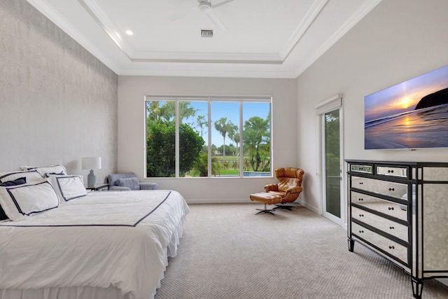 carpeted bedroom with a tray ceiling and ceiling fan